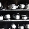Metal Teapots on Shelves, Some Battered from Use, Photography by Errol  Zimmerman
